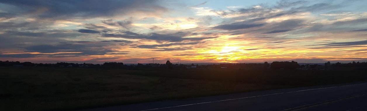 a sun sets in farm country in South Central Pennsylvania